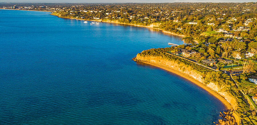 Bird's eye view of Mornington Peninsula coastline at sunset. Melbourne, Victoria, Australia for Exploring the relationship between healthy bays and healthy economies in Victoria