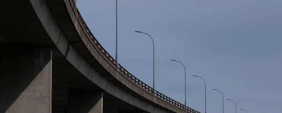 Details of concrete bridge over a river, against a clear blue sky for Environmental indicators for Victorian Government policy