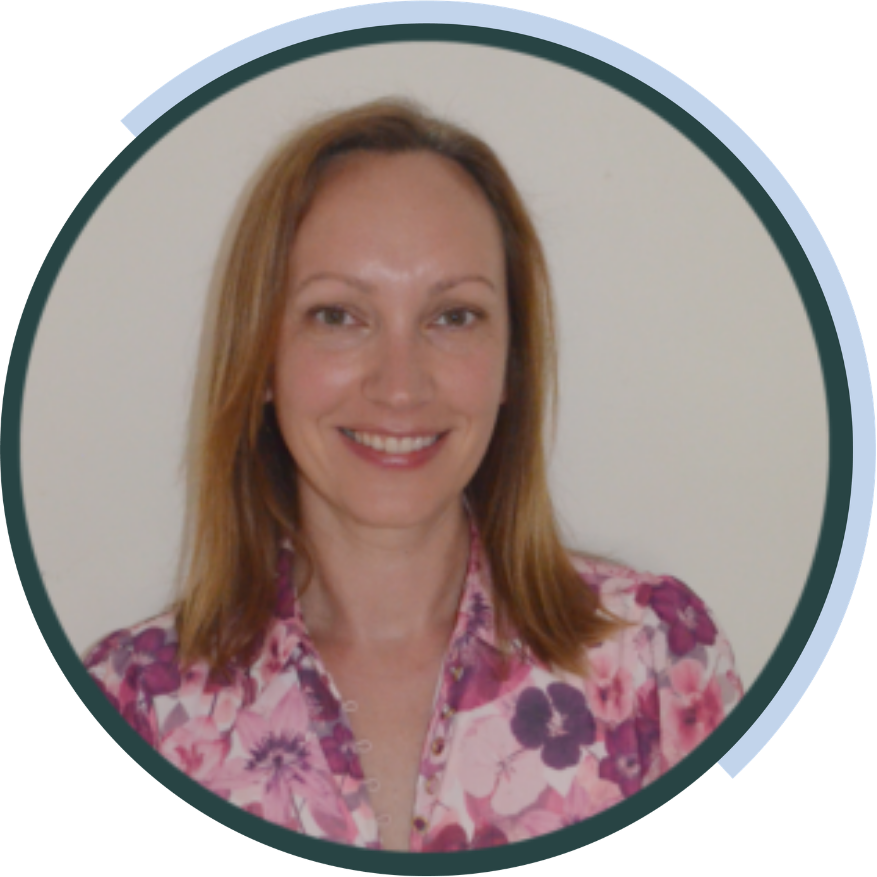Maria Angelopoulos, ideea group team member, smiling in a pink floral blouse