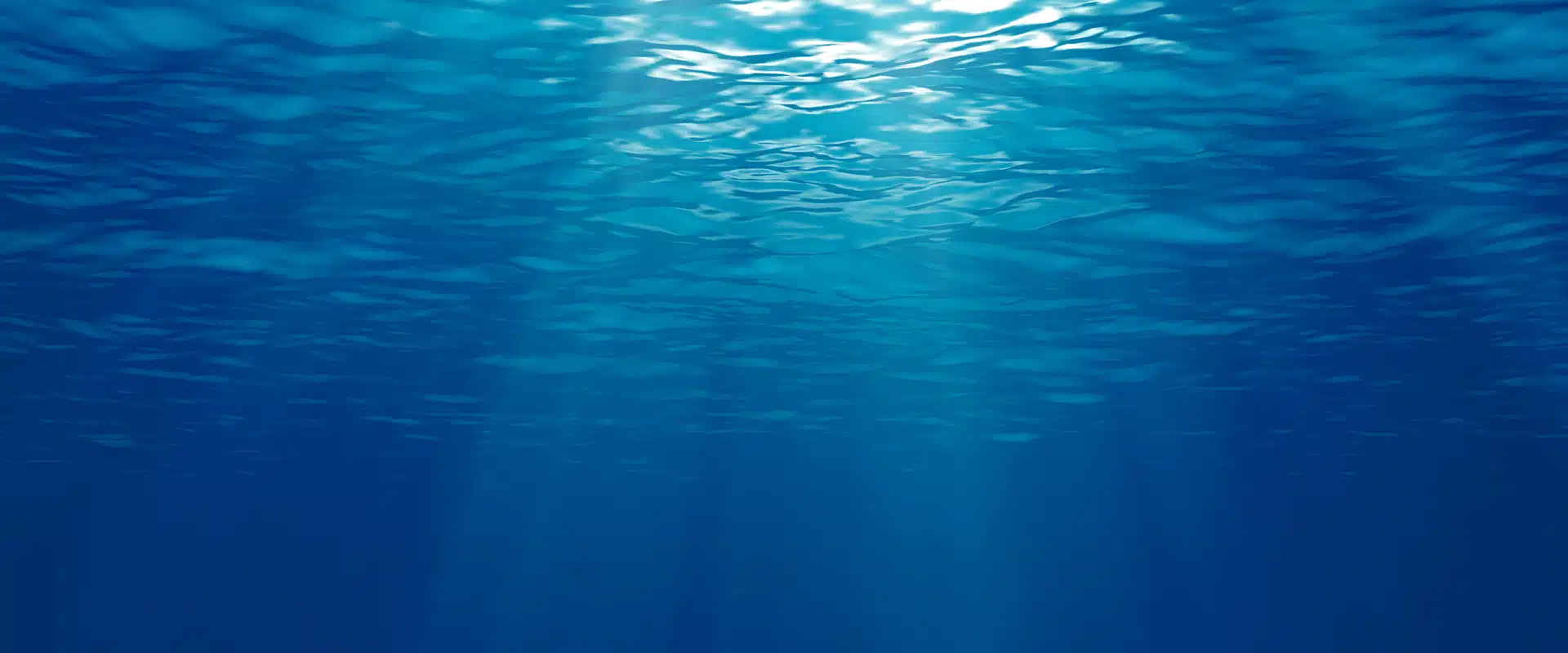 Rays of the sun through bright blue water. Growing the blue economy