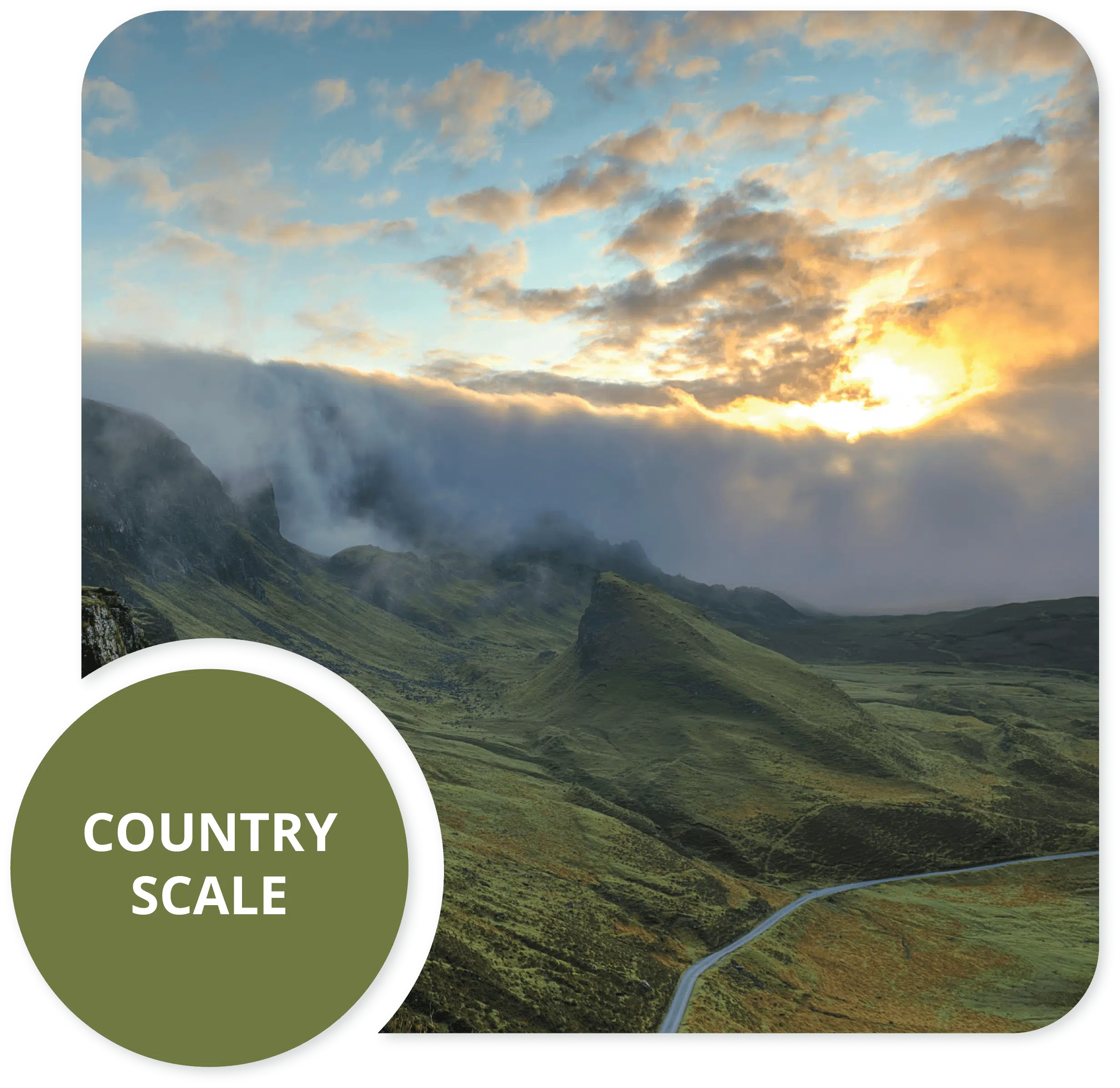 Green mountain valley with a winding road under a golden sunrise sky