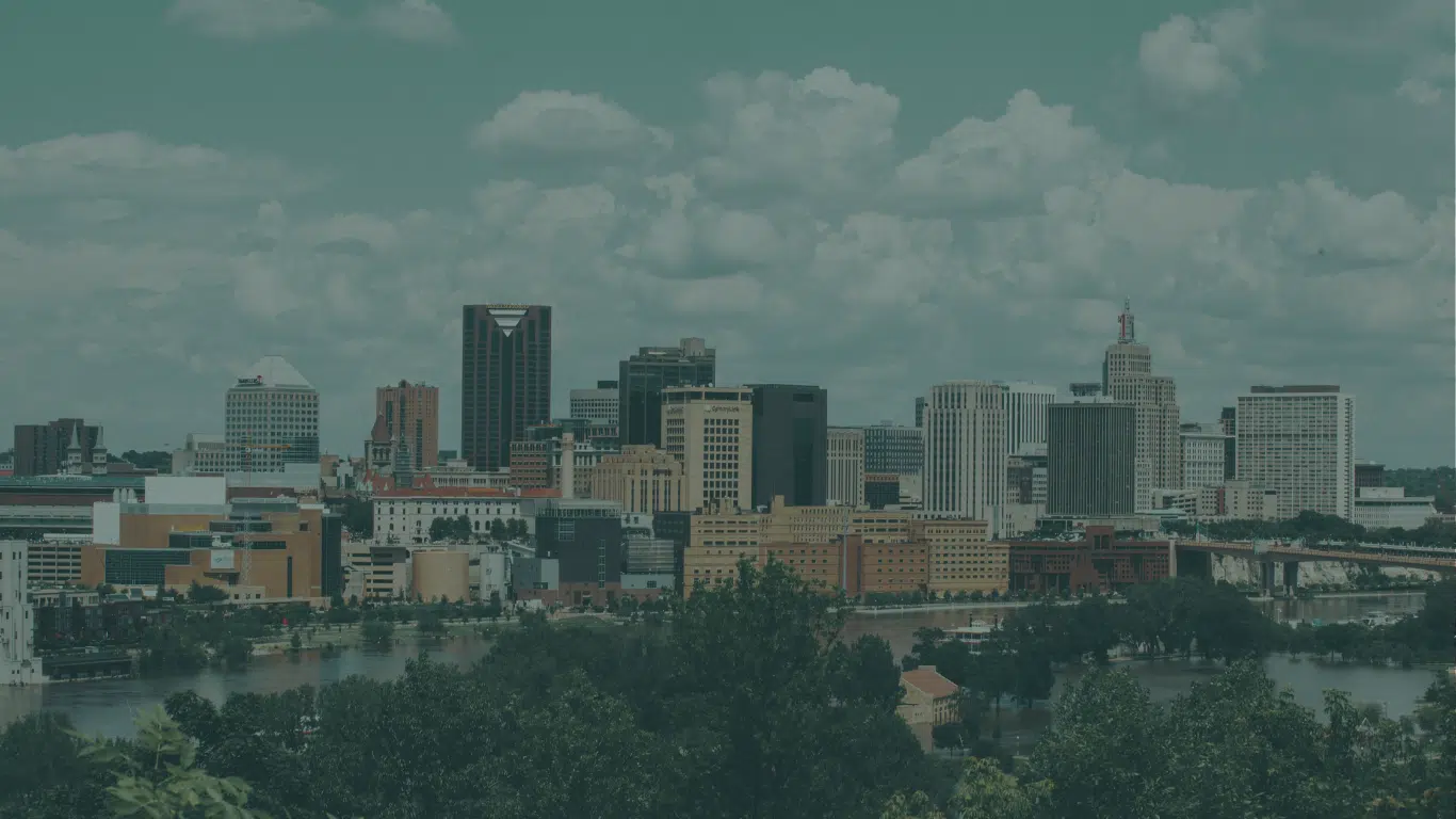 City skyline of office towers under a cloudy sky