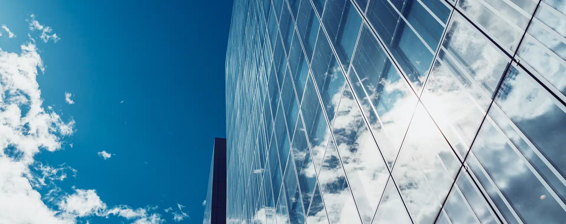 A facade of an office building reflecting blue sky and clouds. Now’s the time to have your say