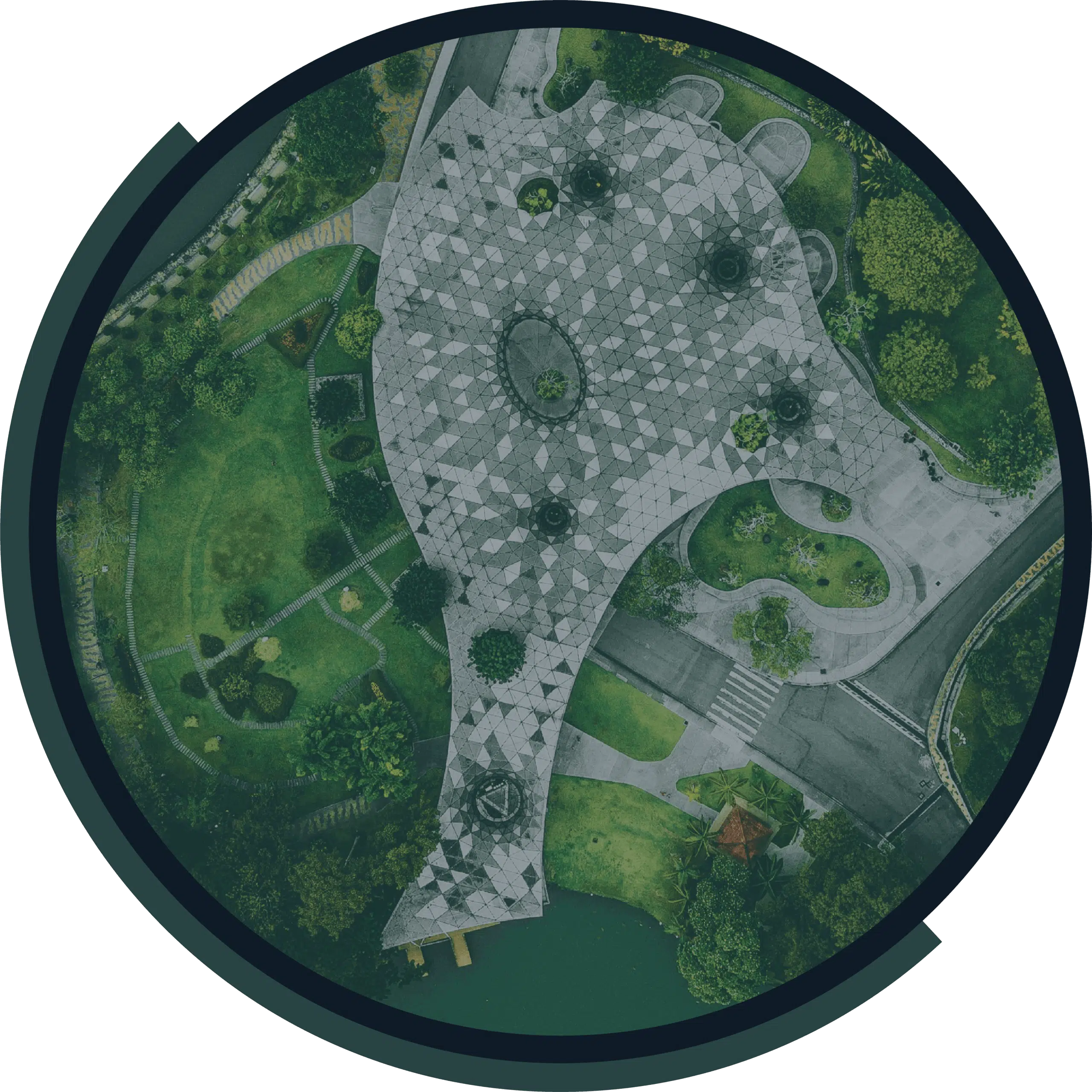 Aerial view of a landscaped park with winding paths, paved plazas and green gardens