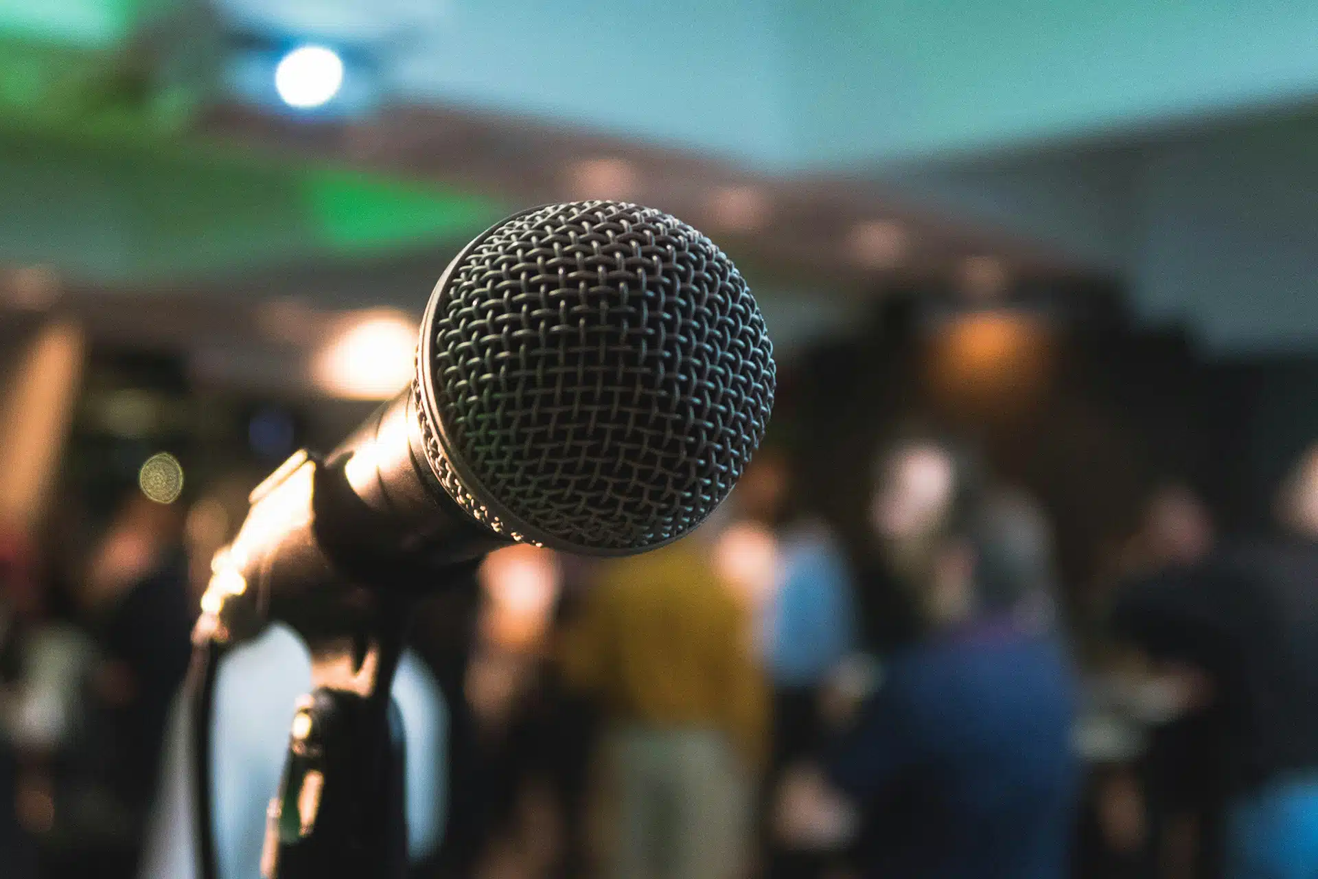A microphone in front of an audience for the Spreading the word post