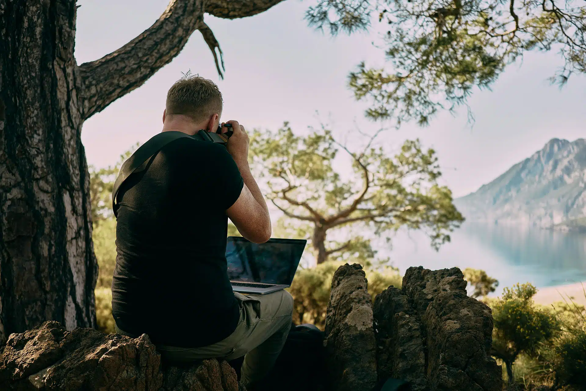 A man working in the Australian bush with a camera and a laptop for a special presentation about natural capital accounting for NRMs