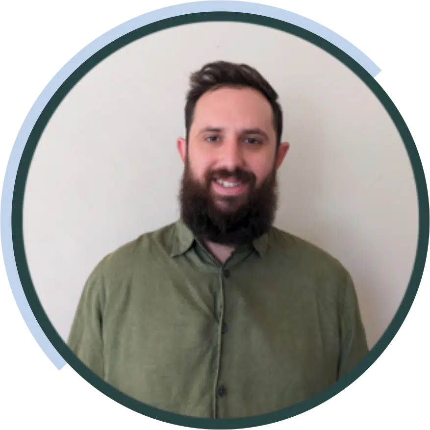 Ziggy Gelman, ideea group team member, smiling with a beard and a green shirt